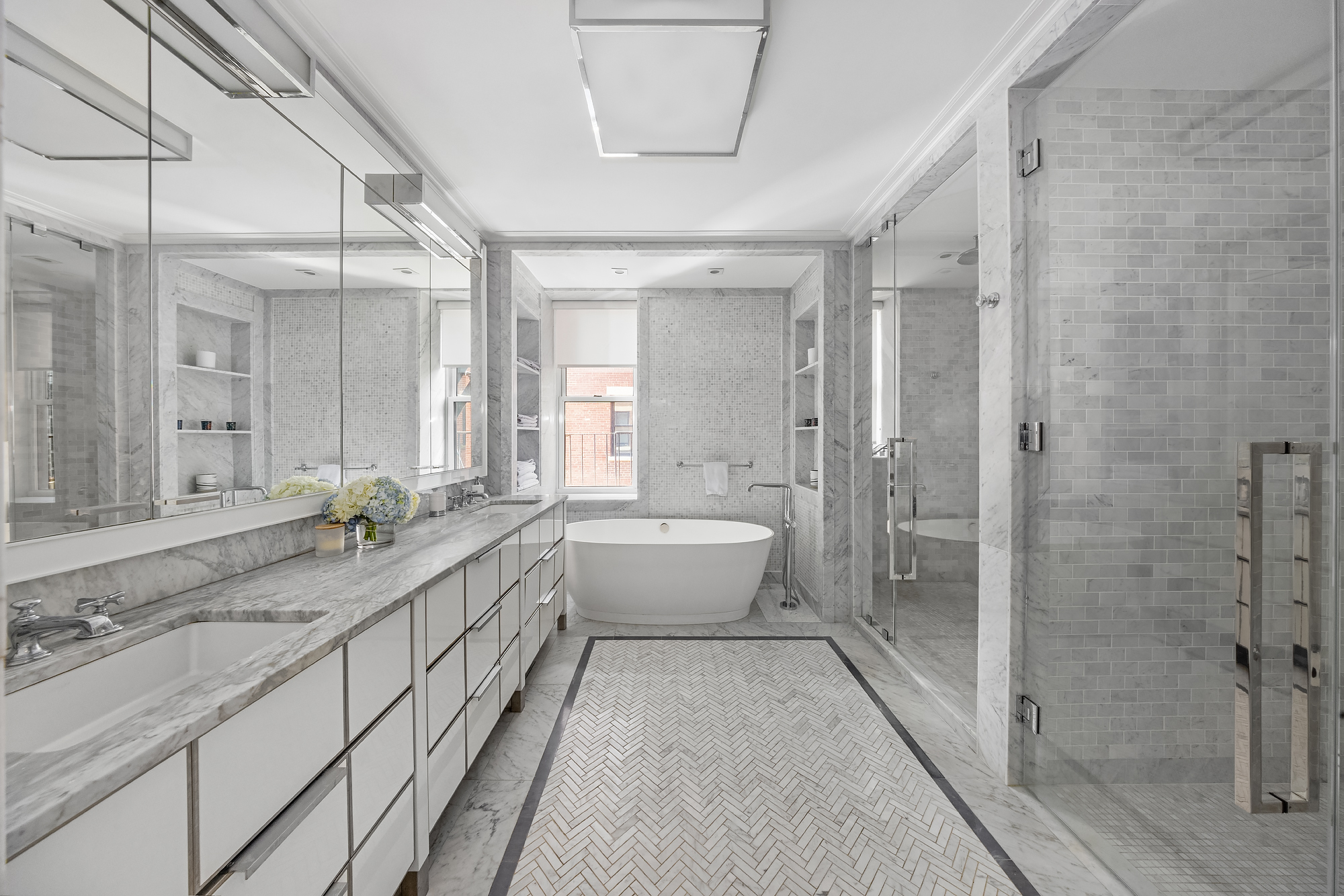 344 West 72nd Street, Unit 1007 Manhattan, NY 10023 - Photo 10 of 23 a spacious bathroom with a double vanity sink mirror and a bathtub