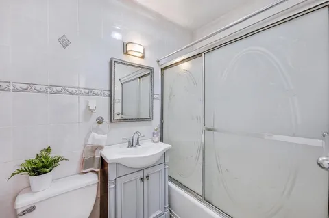 a bathroom with a sink a mirror and a shower