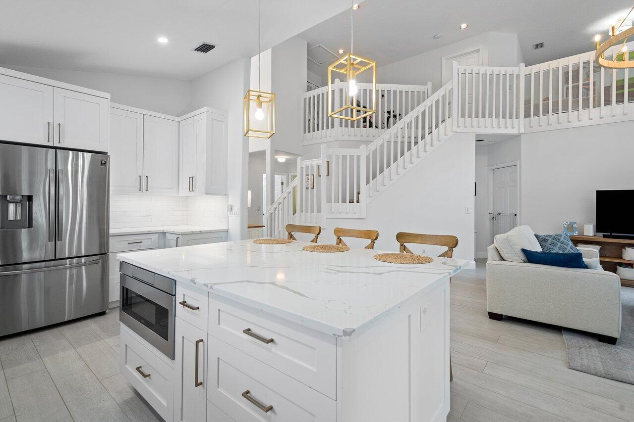 1182 Canoe Point Delray Beach, FL 33444 - Photo 13 of 46 a view of kitchen with furniture and wooden floor