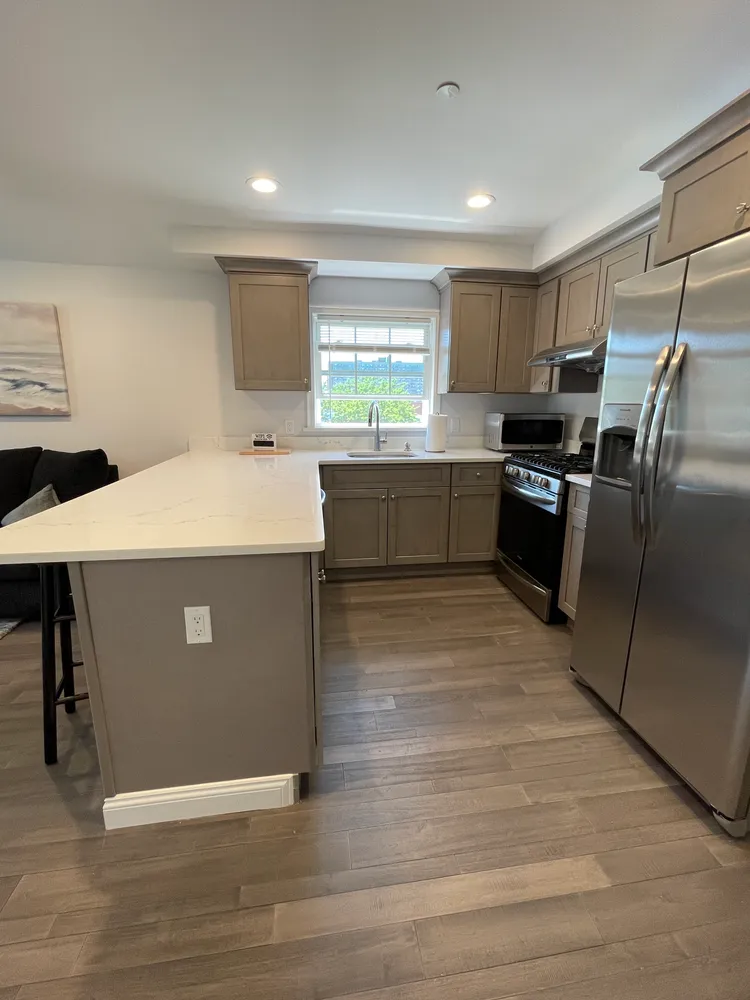 a large kitchen with stainless steel appliances granite countertop a sink counter space and a window
