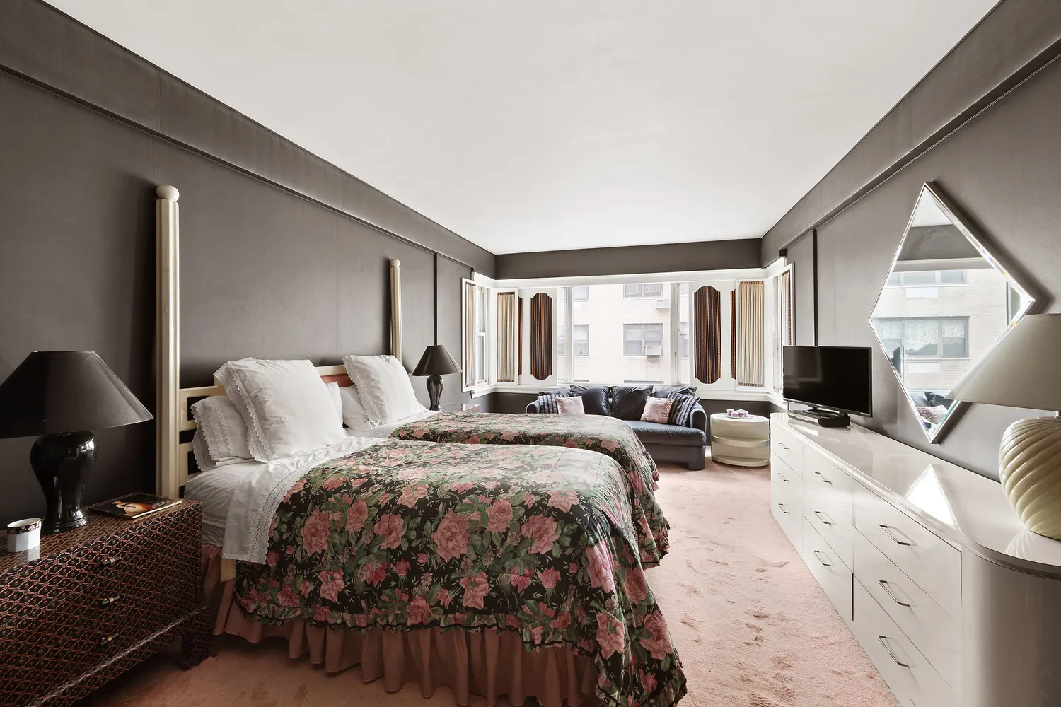 a bedroom with a bed a couch and dresser