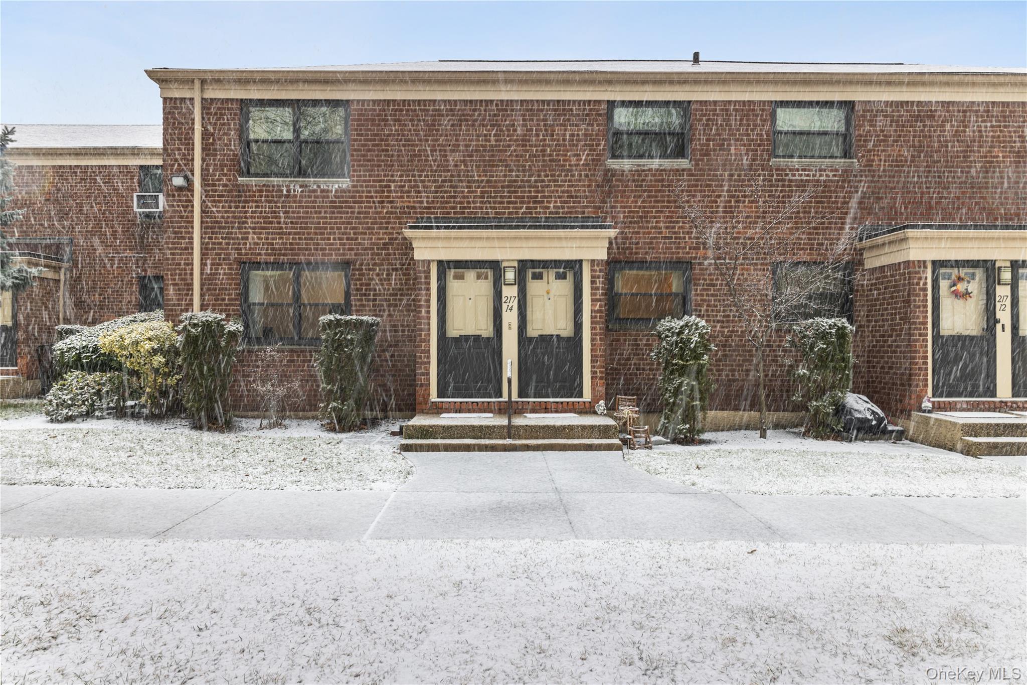 217-14 73rd Avenue, Unit 1 Queens, NY 11364 - Photo 2 of 19 a view of a brick building next to a yard