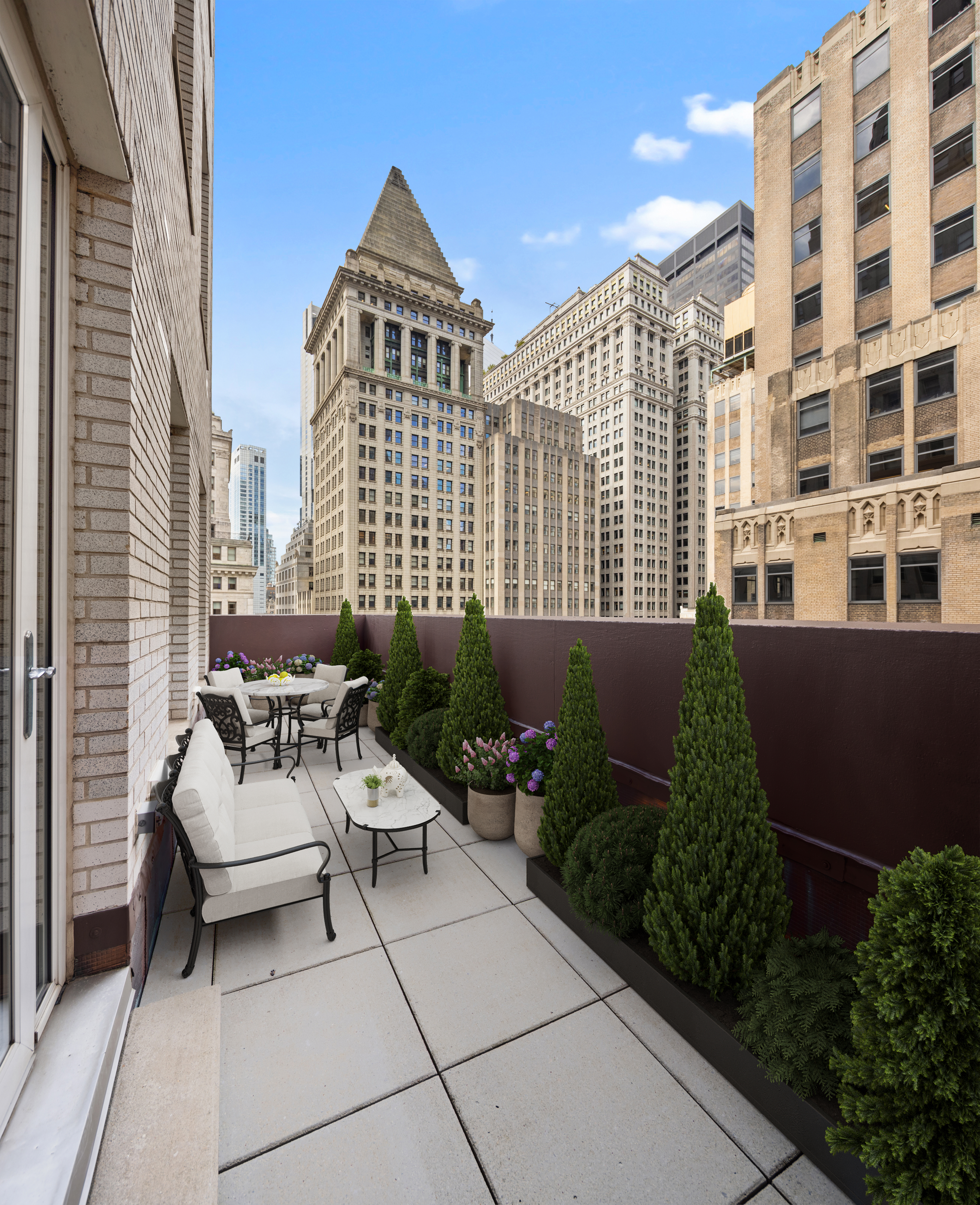15 Broad Street, Unit 1900 Manhattan, NY 10005 - Photo 4 of 29 a view of a patio with couches and potted plants
