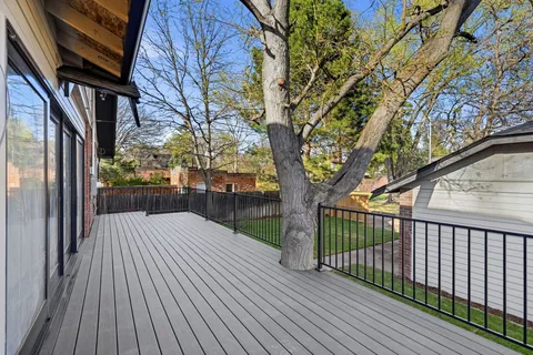 a view of backyard with a deck