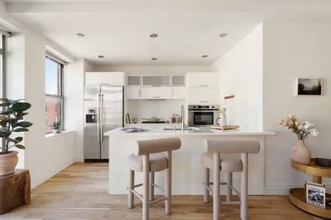 a kitchen with kitchen island cabinets and wooden floor