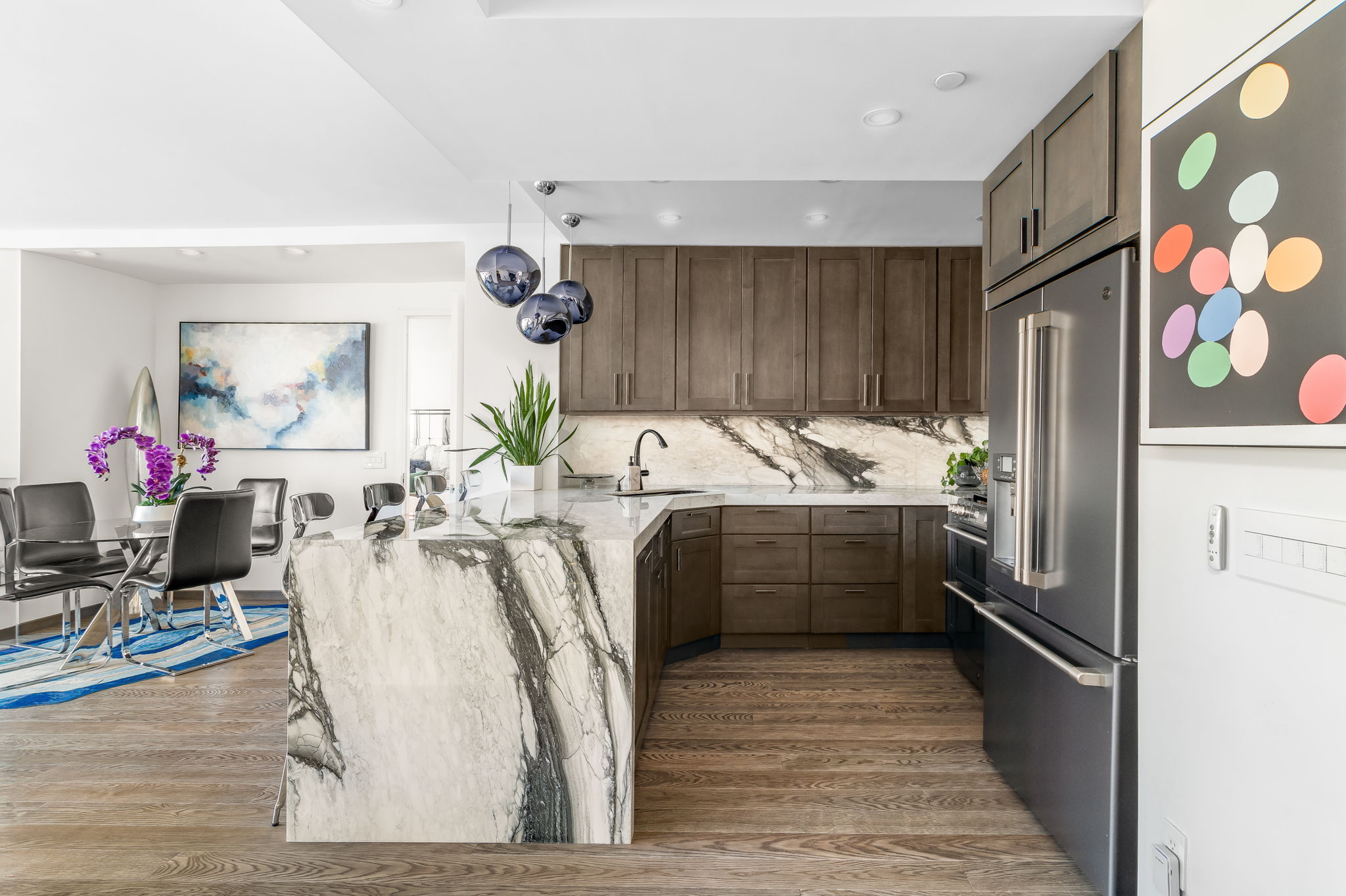 350 West 53rd Street, Unit PHB Manhattan, NY 10019 - Photo 11 of 34 a kitchen with stainless steel appliances kitchen island granite countertop a refrigerator and a sink