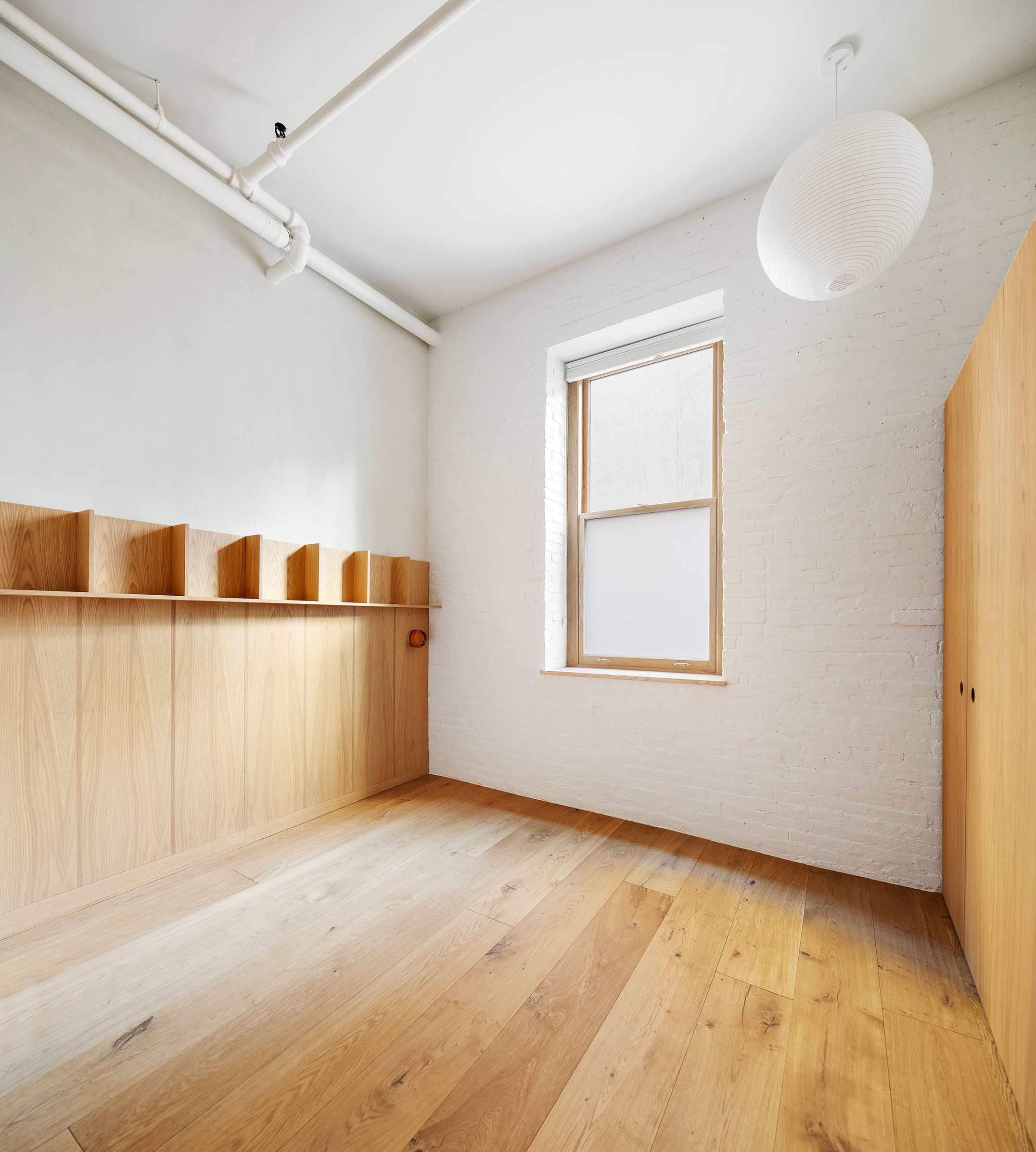 140 Sullivan Street, Unit 1FR Manhattan, NY 10012 - Photo 10 of 19 a view of an empty room with a window