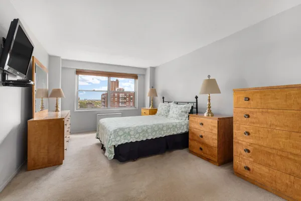 a bed room with a bed and a television