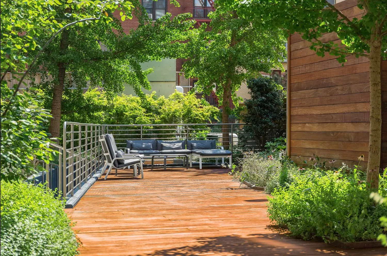 a backyard of a house with table and chairs with plants