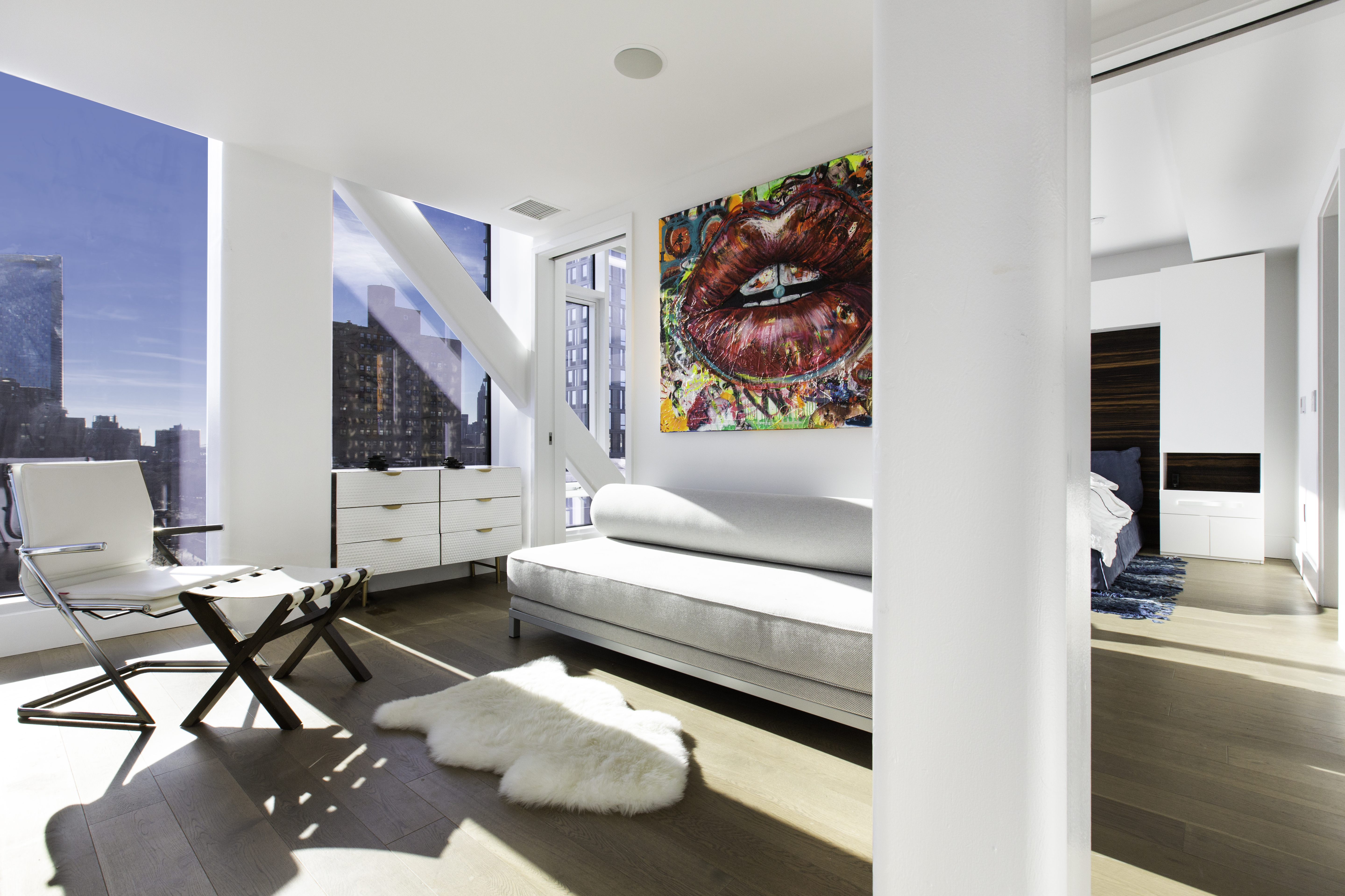 100 Norfolk Street, Unit PH Manhattan, NY 10002 - Photo 19 of 23 a living room with furniture and a painting on the wall