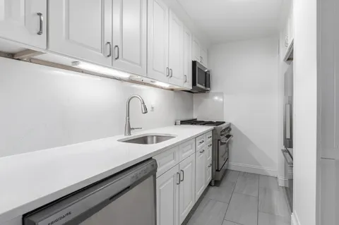 a kitchen with a sink and cabinets