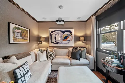 a bedroom with furniture and a large window