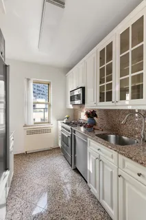 a kitchen with stainless steel appliances granite countertop a stove a sink and a granite counter tops