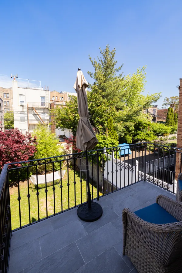 a view of a swimming pool with a chairs and table in the patio