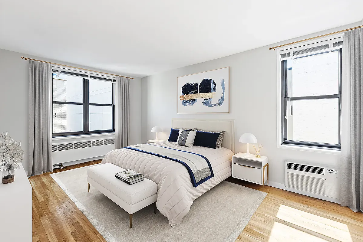 85 4th Avenue, Unit 3B Manhattan, NY 10003 - Photo 4 of 9 a bedroom with a bed lamp and a window