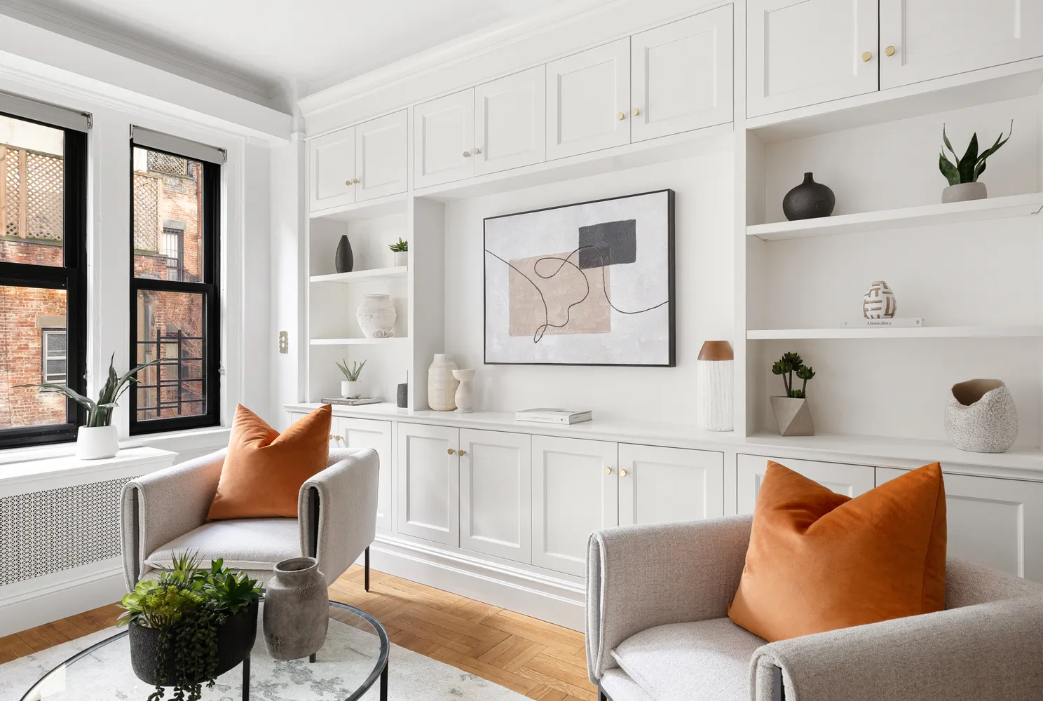 a living room with furniture and a potted plant