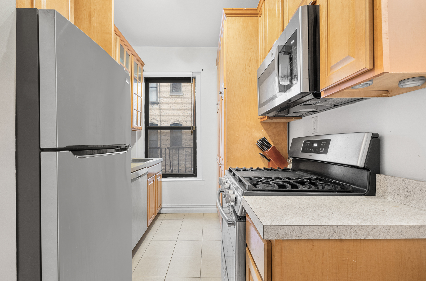 255 Eastern Parkway, Unit C5 Brooklyn, NY 11238 - Photo 5 of 9 a kitchen with stainless steel appliances granite countertop a refrigerator and a stove