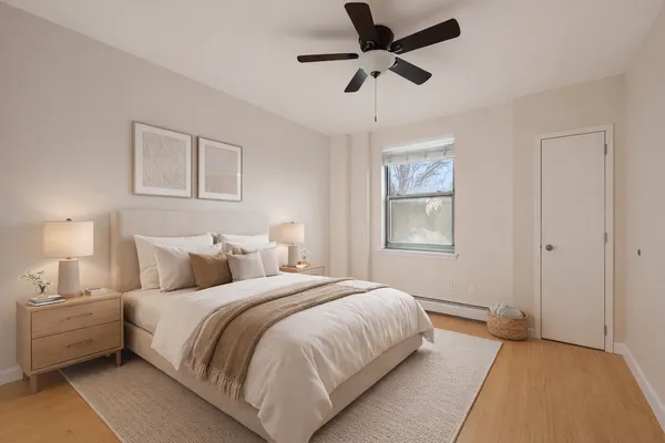 a bedroom with a large bed and a window