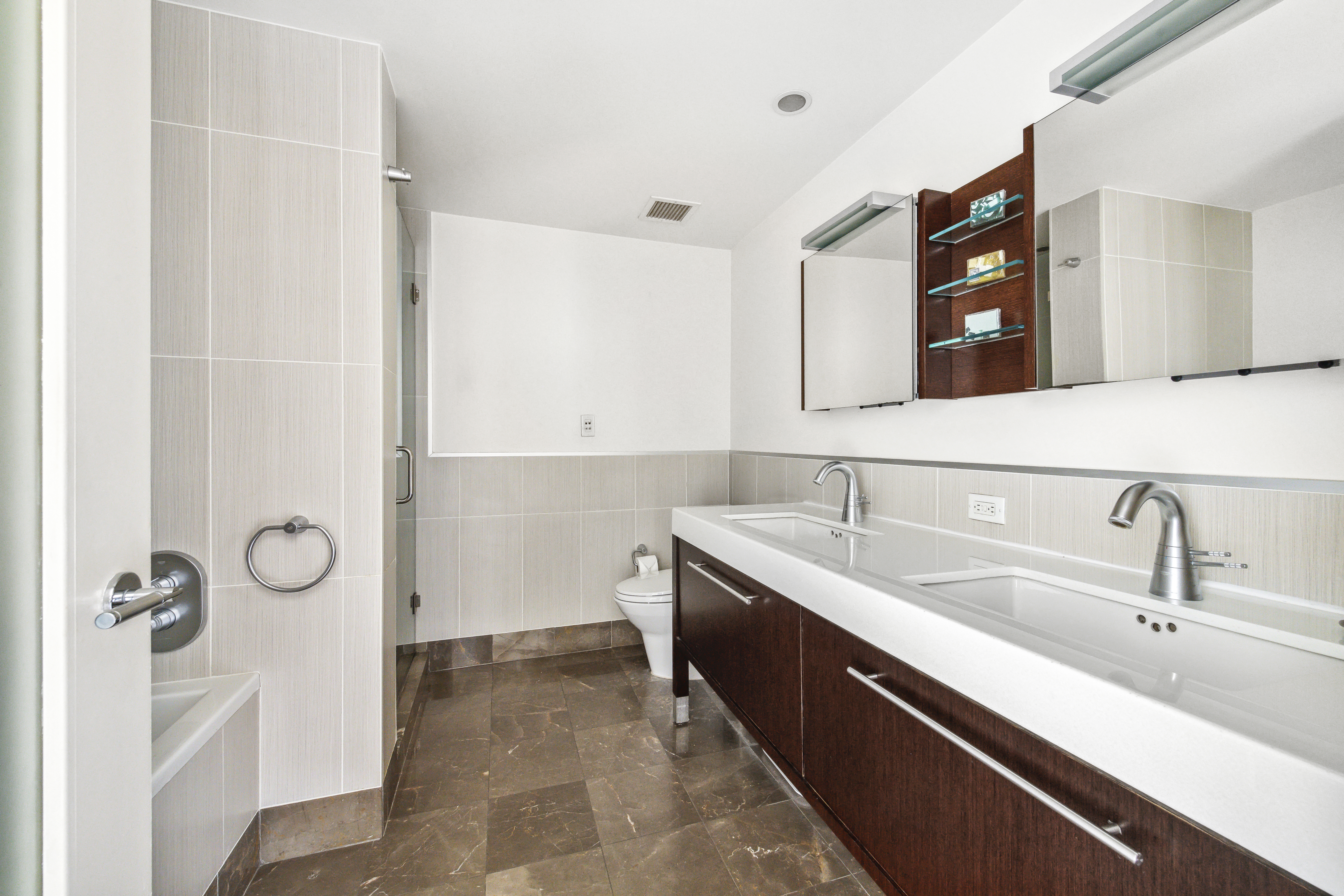 225 East 34th Street, Unit 9C Manhattan, NY 10016 - Photo 5 of 19 a bathroom with a sink and a mirror