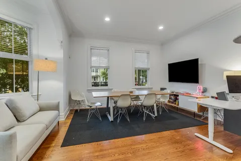 a living room with furniture a rug and a flat screen tv