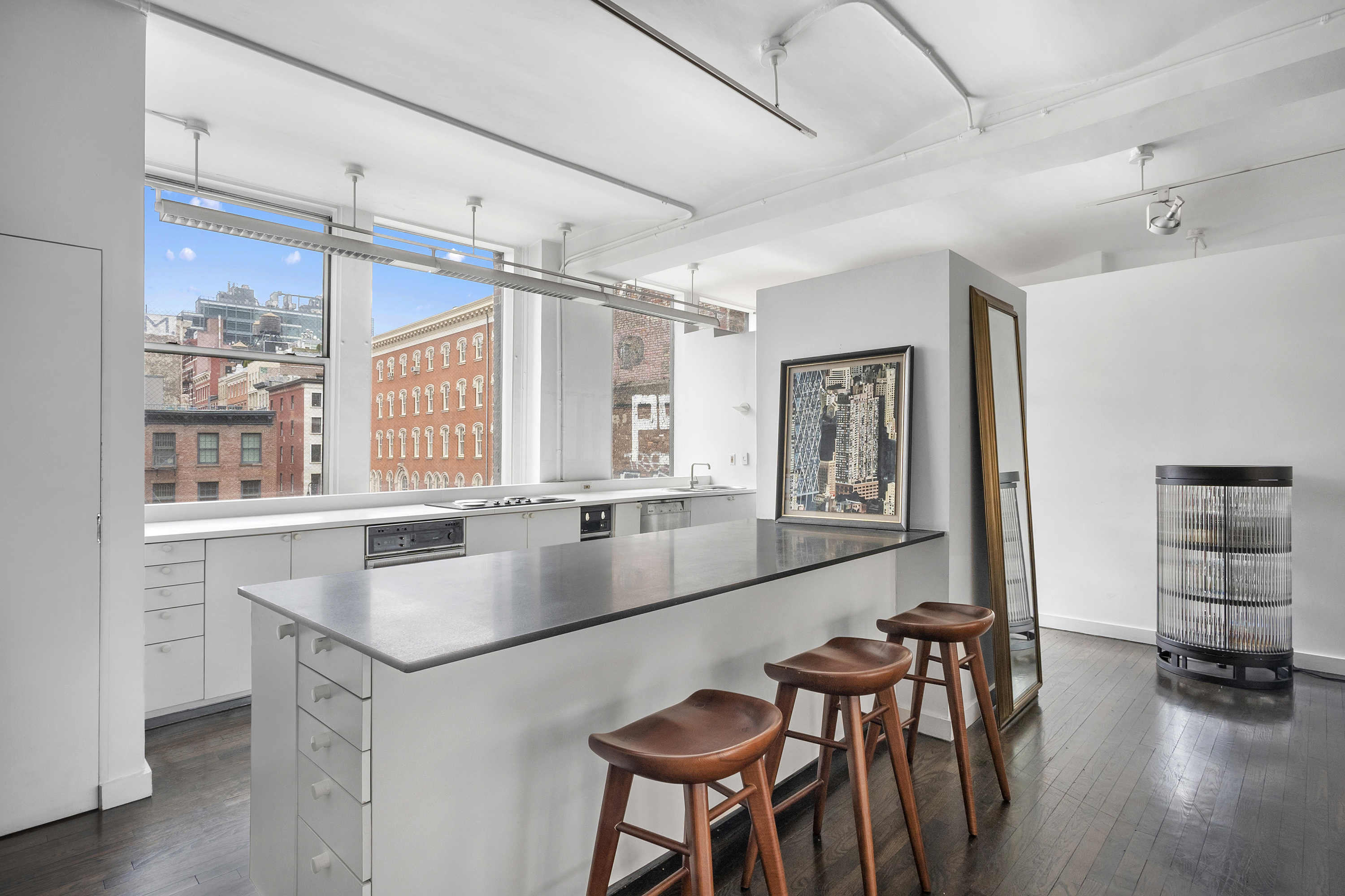 45 Lispenard Street, Unit 3E Manhattan, NY 10013 - Photo 2 of 9 a kitchen with center island and stainless steel appliances