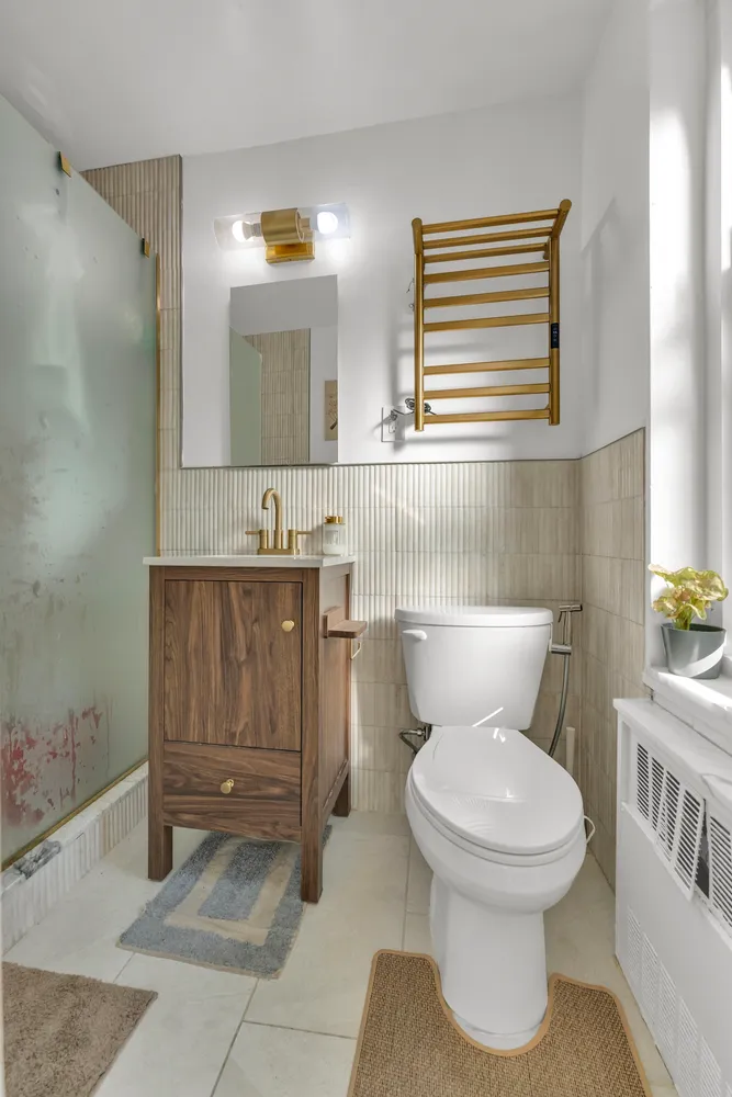 a bathroom with a toilet a sink and mirror