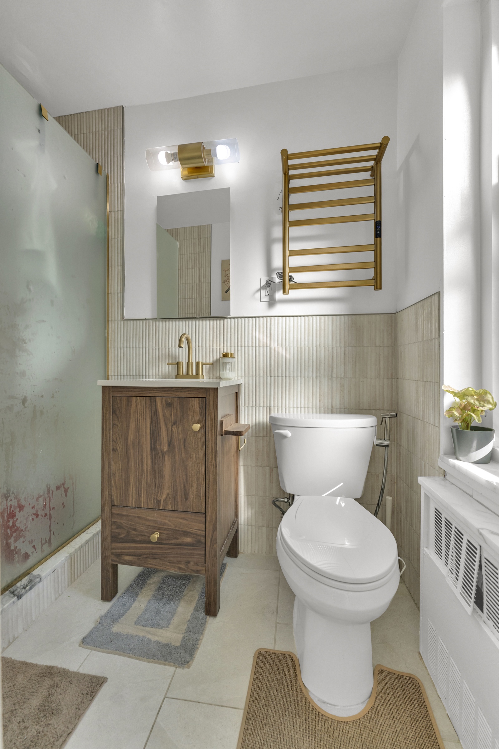 150 West End Avenue, Unit 21M Manhattan, NY 10023 - Photo 9 of 13 a bathroom with a toilet a sink and mirror