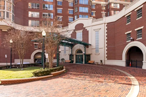 a front view of a building with a garden