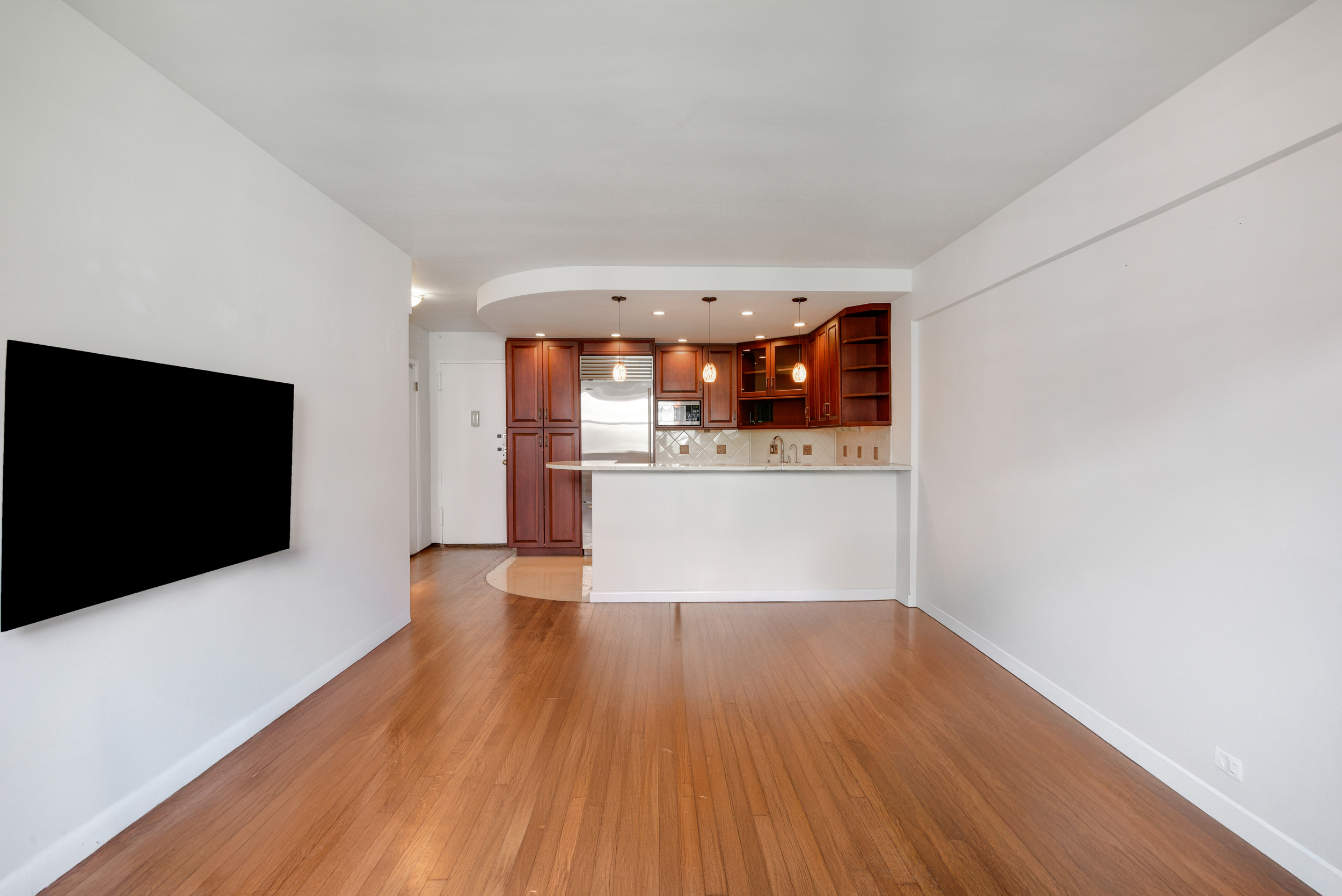 88 Bleecker Street, Unit 5J Manhattan, NY 10012 - Photo 2 of 18 a view of a kitchen with wooden floor and a fireplace