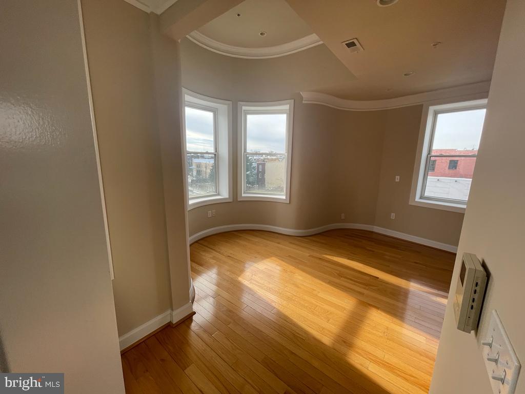1033 Park Road Northwest, Unit 6 Washington, DC 20010 - Photo 1 of 38 a view of empty room with wooden floor and fan