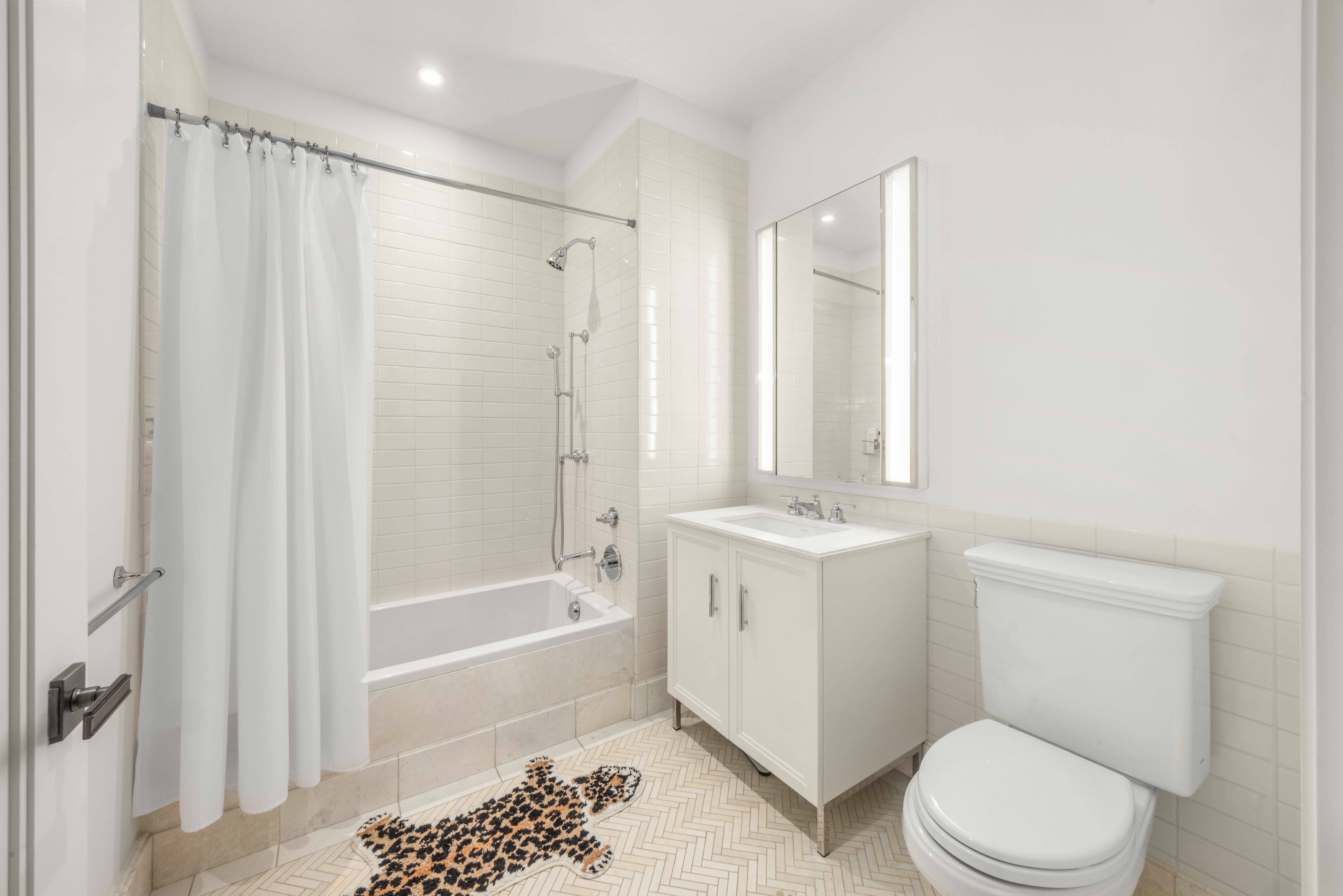 100 Barclay Street, Unit 16H Manhattan, NY 10007 - Photo 8 of 12 a bathroom with a sink toilet and shower
