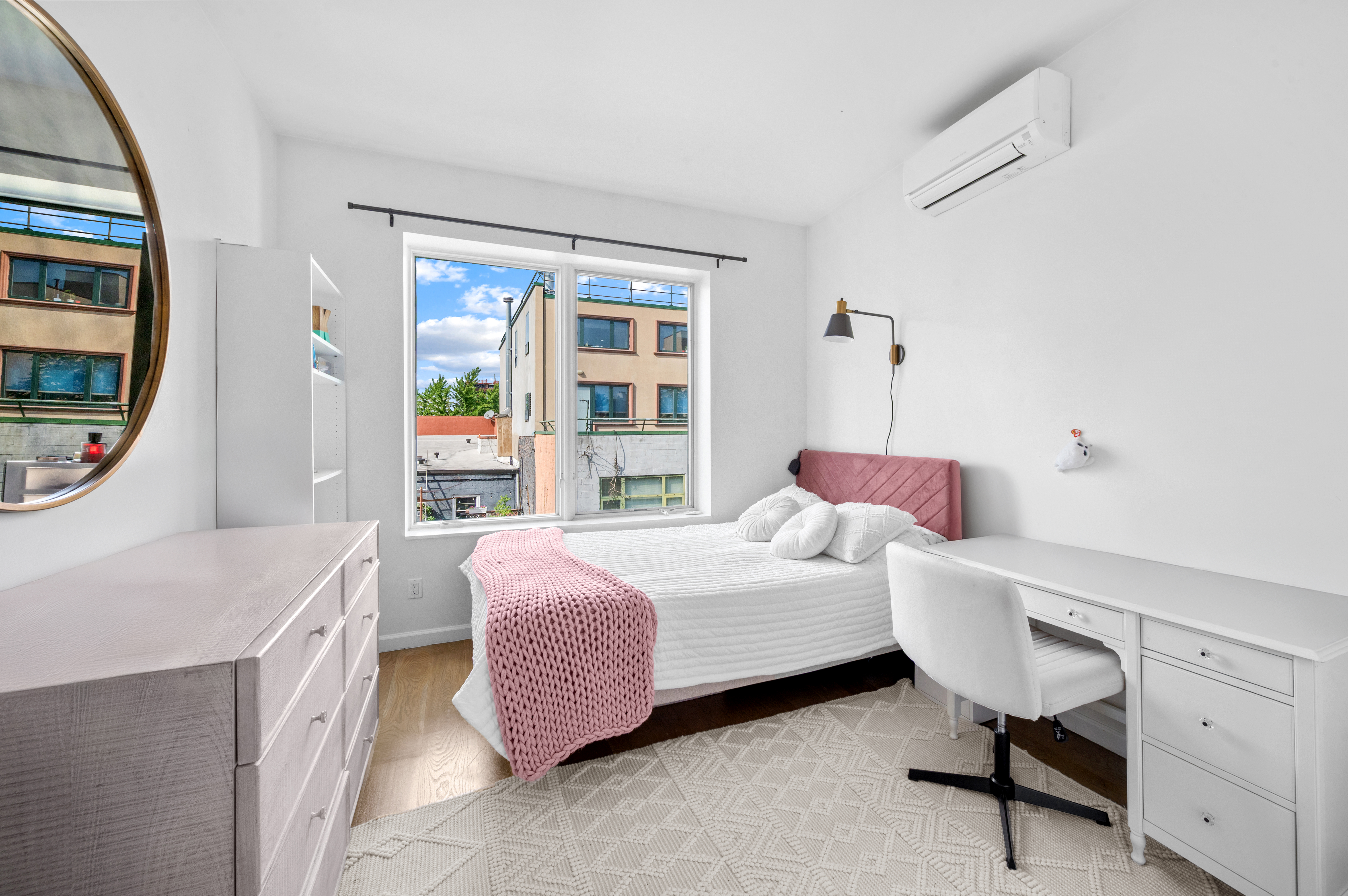 5-41 47th Road, Unit 2B Queens, NY 11101 - Photo 6 of 10 a bedroom with a bed chair and a window