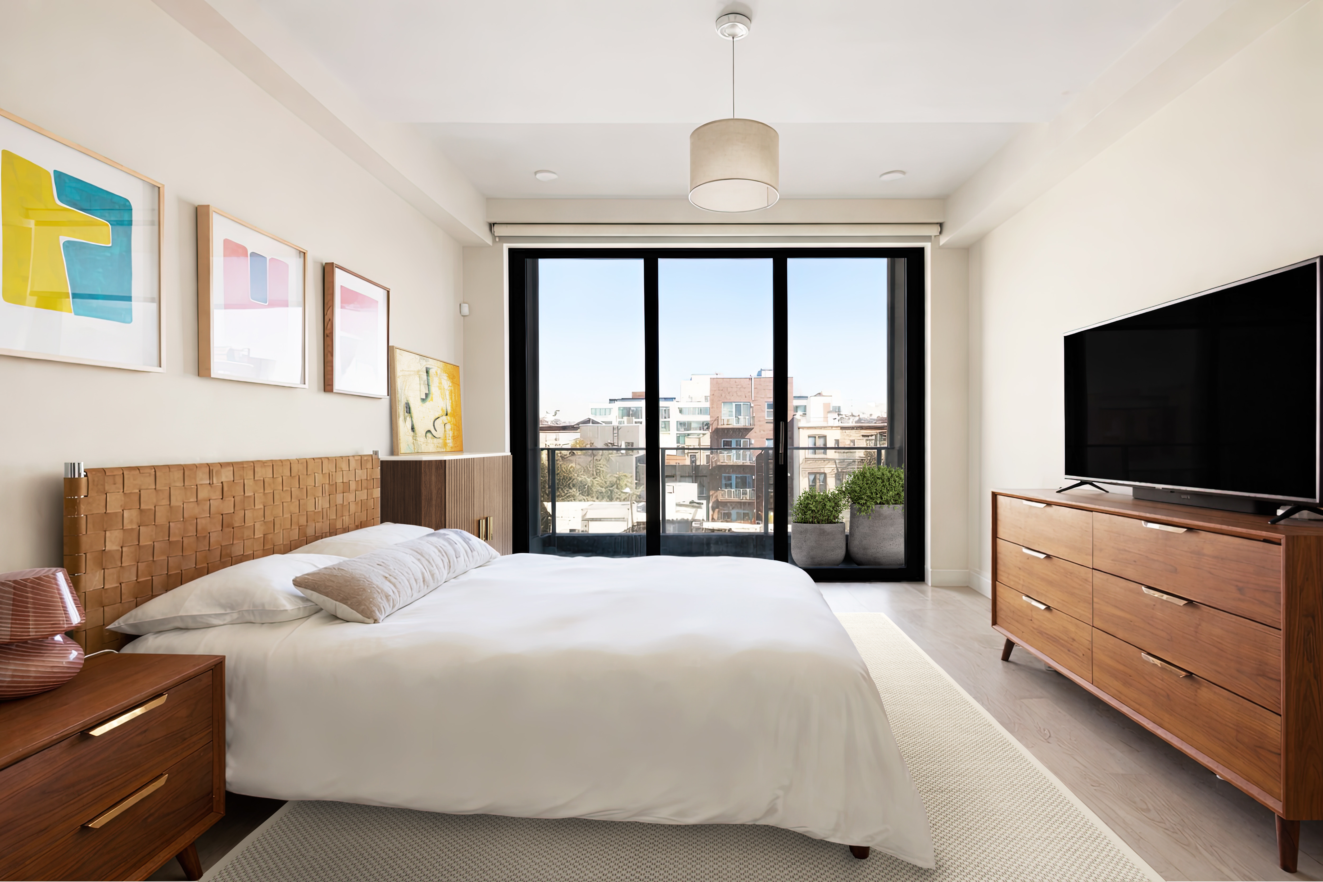 170 South 1st Street, Unit 4B Brooklyn, NY 11211 - Photo 5 of 11 a bedroom with a bed and a flat screen tv