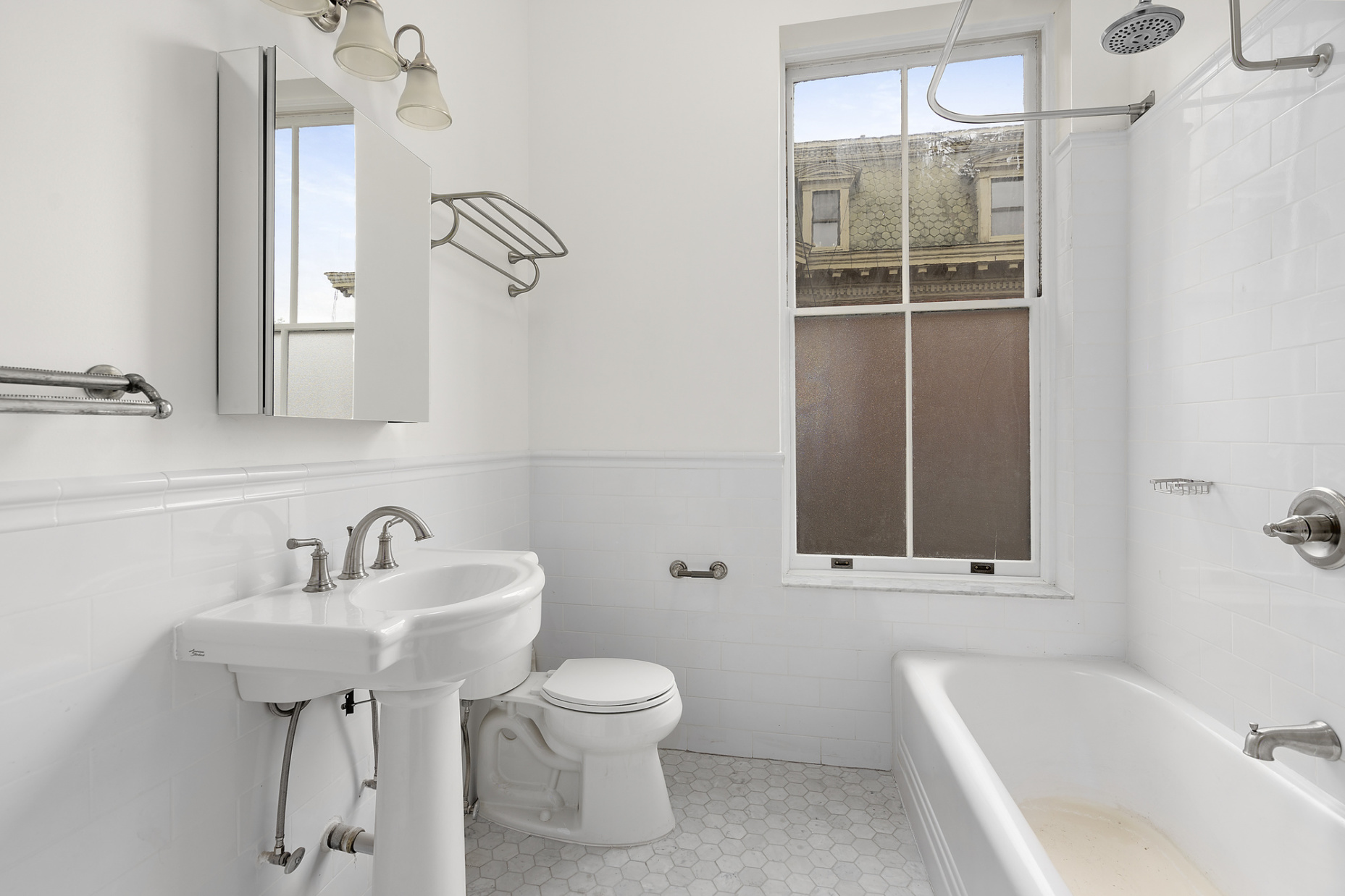 419 Clinton Avenue, Unit 2B Brooklyn, NY 11238 - Photo 5 of 7 a bathroom with a sink a toilet and shower