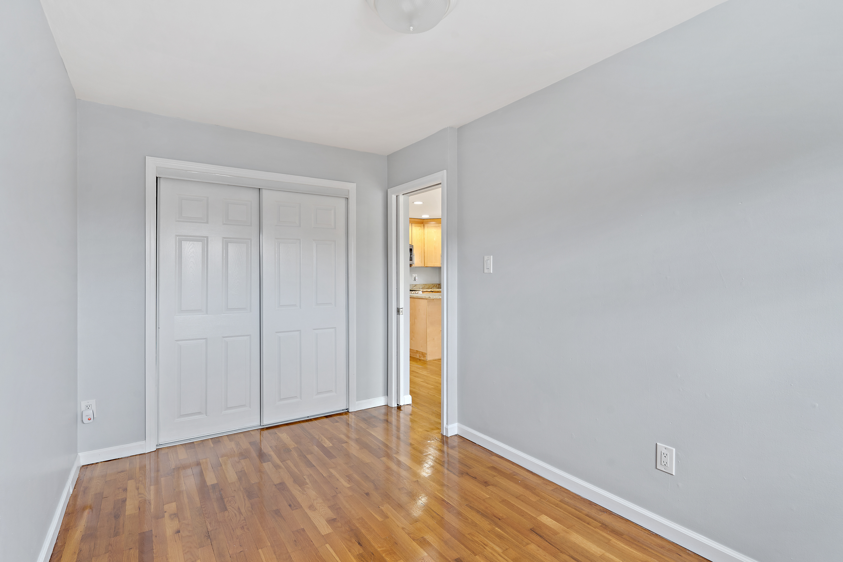 3230 Johnson Avenue, Unit 3 Bronx, NY 10463 - Photo 10 of 21 a view of an empty room with wooden floor and closet