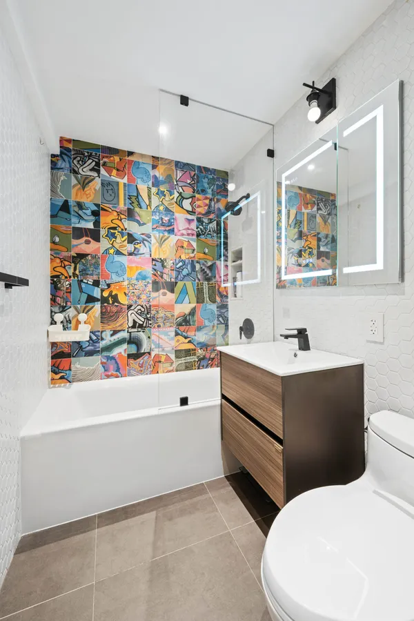 a bathroom with a sink a mirror and a toilet