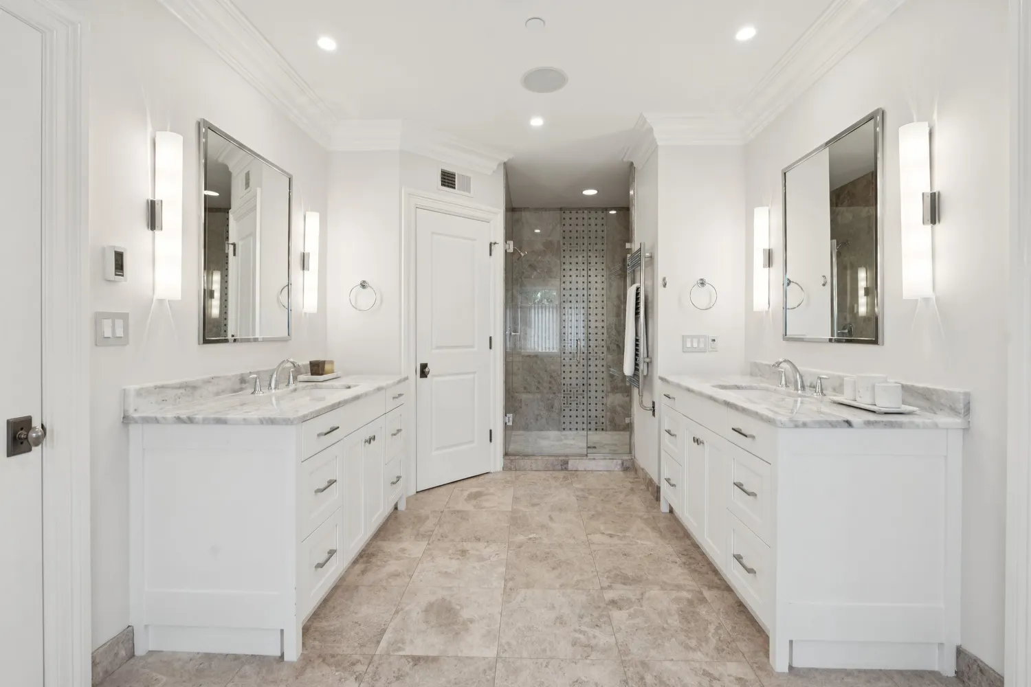 a bedroom with a white bed and a large mirror