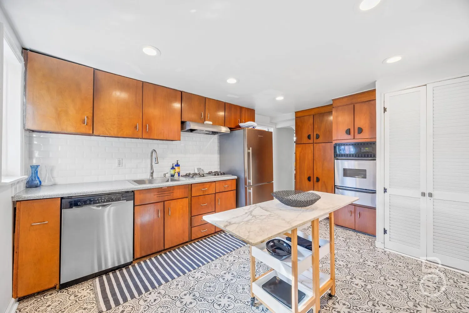 a kitchen with stainless steel appliances granite countertop a sink and cabinets
