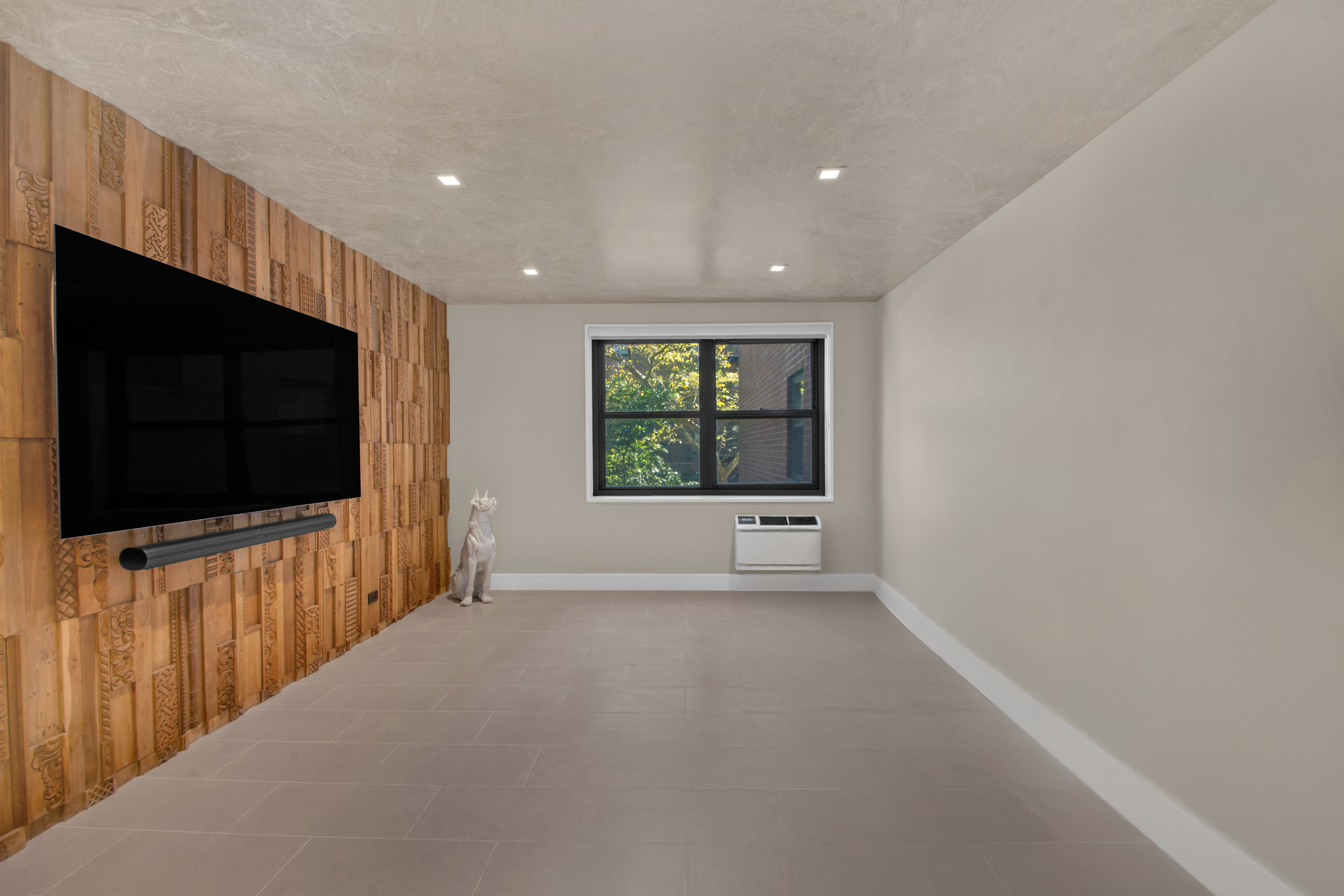 690 Washington Street, Unit 1A Manhattan, NY 10014 - Photo 7 of 17 a view of an empty room with a flat screen tv