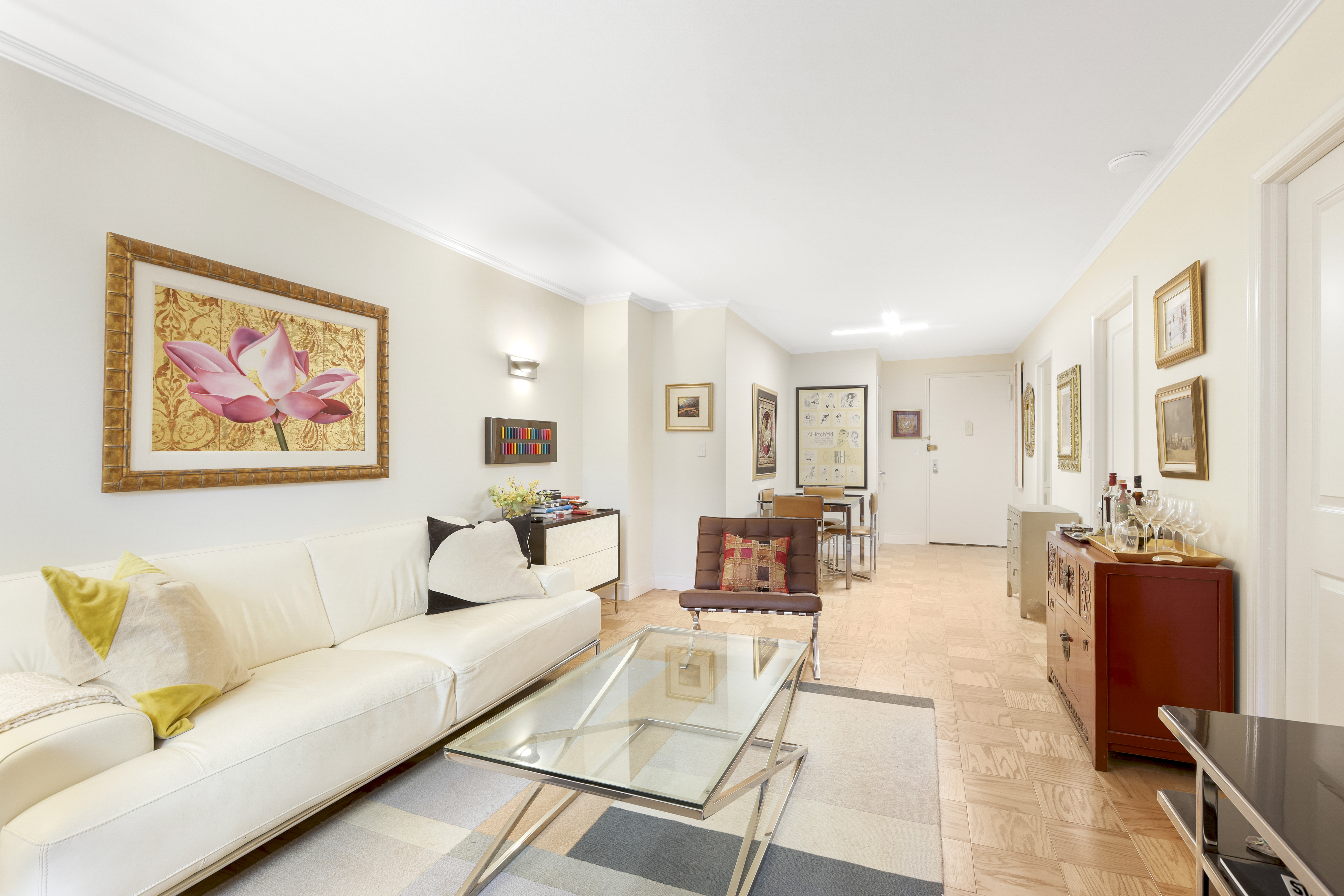 165 West 66th Street, Unit 2S Manhattan, NY 10023 - Photo 2 of 7 a living room with furniture two couch and a dining table with wooden floor