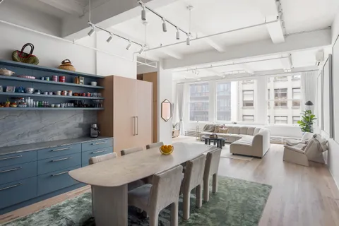 a large kitchen with a table and chairs
