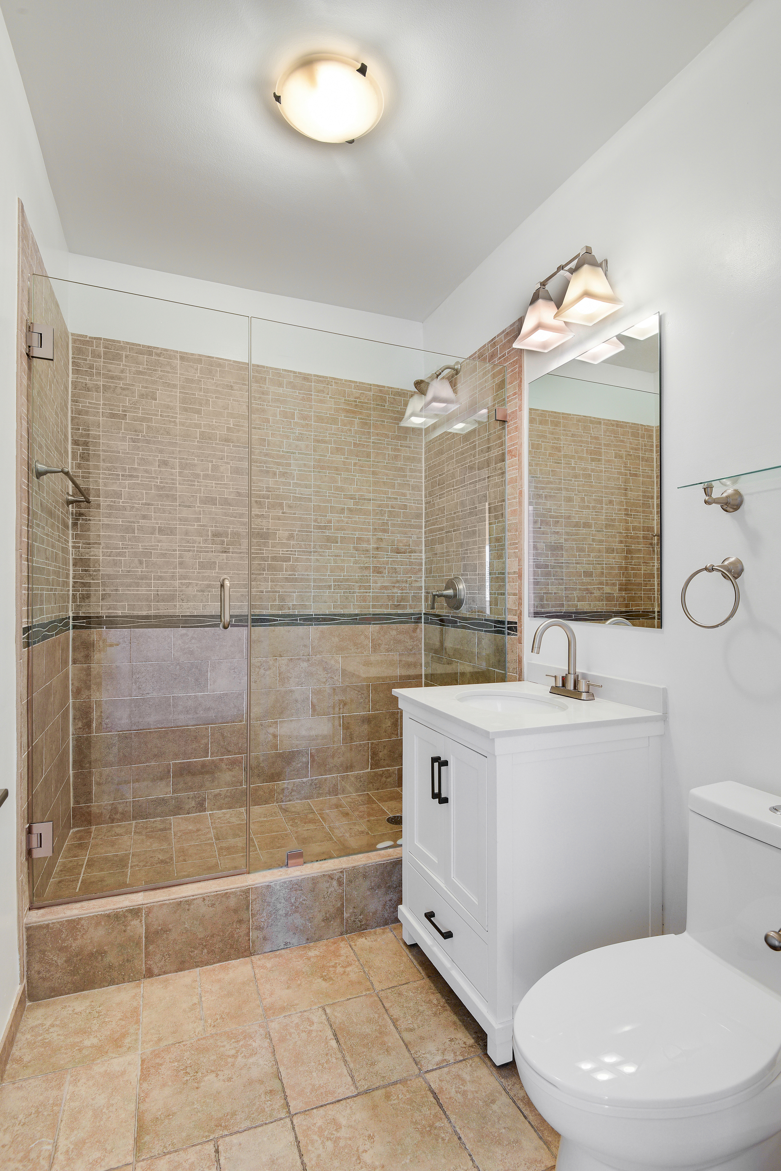 360 East 88th Street, Unit 22C Manhattan, NY 10128 - Photo 16 of 33 a bathroom with a sink a toilet and mirror