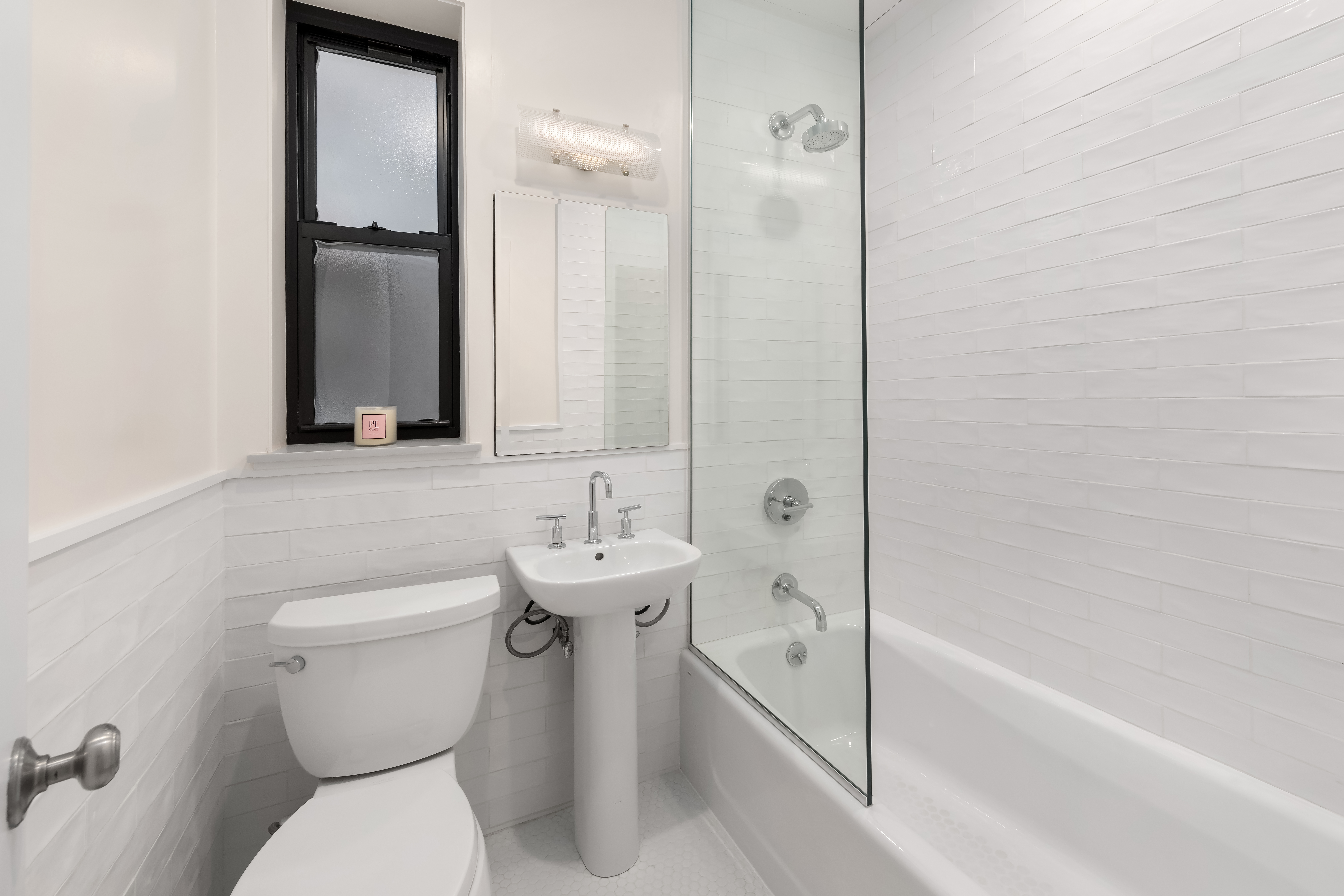 212 East 13th Street, Unit 4D Manhattan, NY 10003 - Photo 5 of 8 a bathroom with a toilet sink and a bathtub