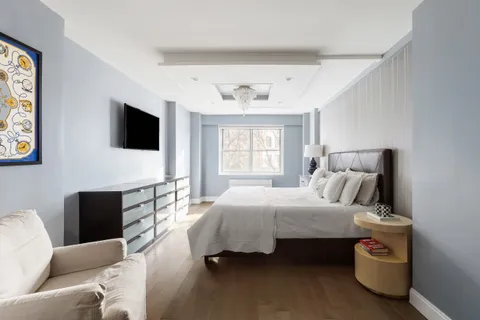 a bedroom with a bed and glass window