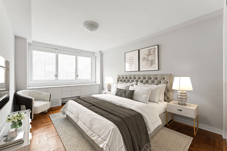 20 East 68th Street, Unit 11B Manhattan, NY 10065 - Photo 2 of 10 a bedroom with a bed and a window