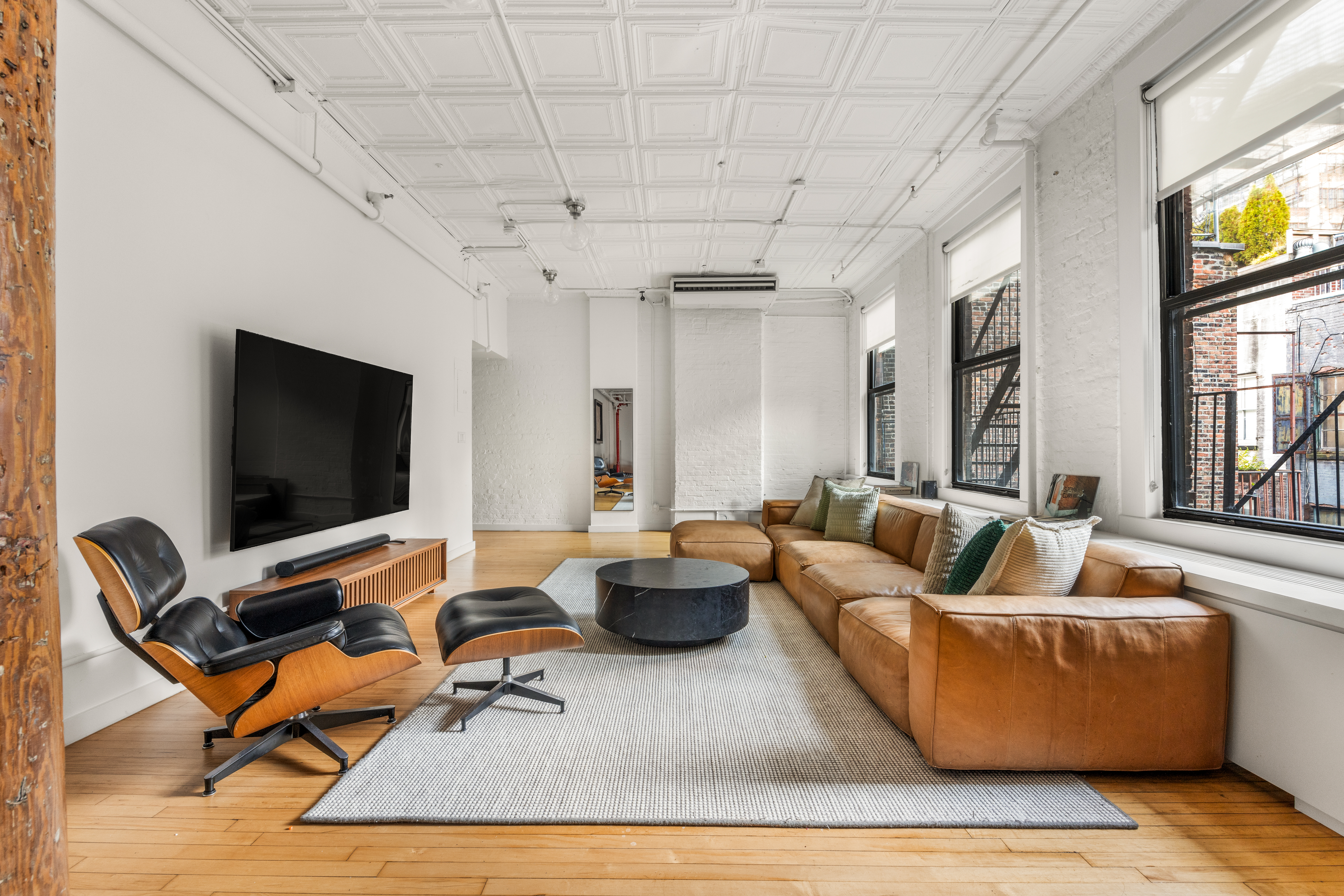 5 White Street, Unit 5B Manhattan, NY 10013 - Photo 3 of 21 a living room with furniture and a flat screen tv