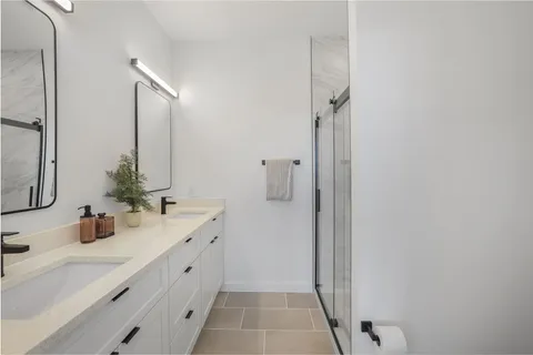 a bathroom with a double vanity sink and mirror