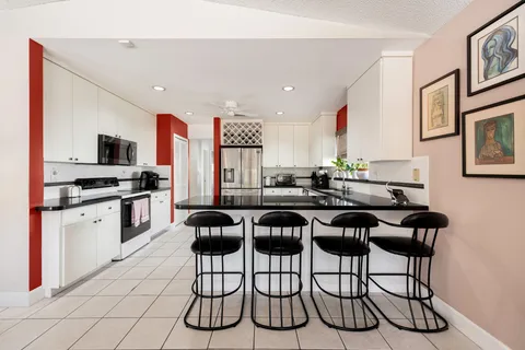 a kitchen with a table chairs stove and cabinets