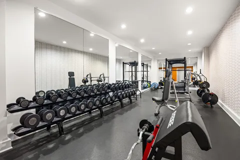 a large room with gym equipment and a large window