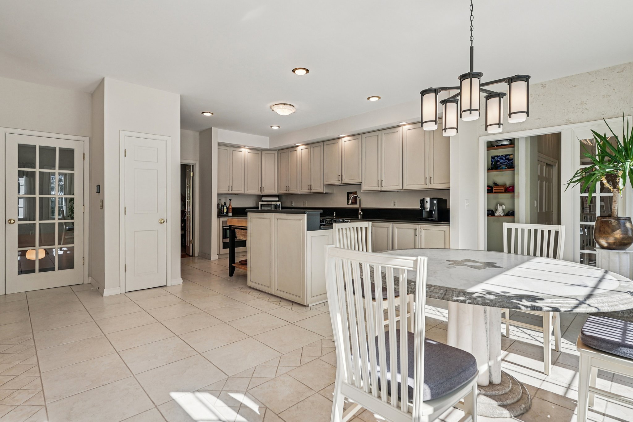 905 Kip Lane Neshanic Station, NJ 08853 - Photo 16 of 50 a kitchen with stainless steel appliances kitchen island granite countertop a dining table chairs and granite counter tops